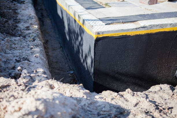Professional Basement Waterproofing technician working in Houghton, MI